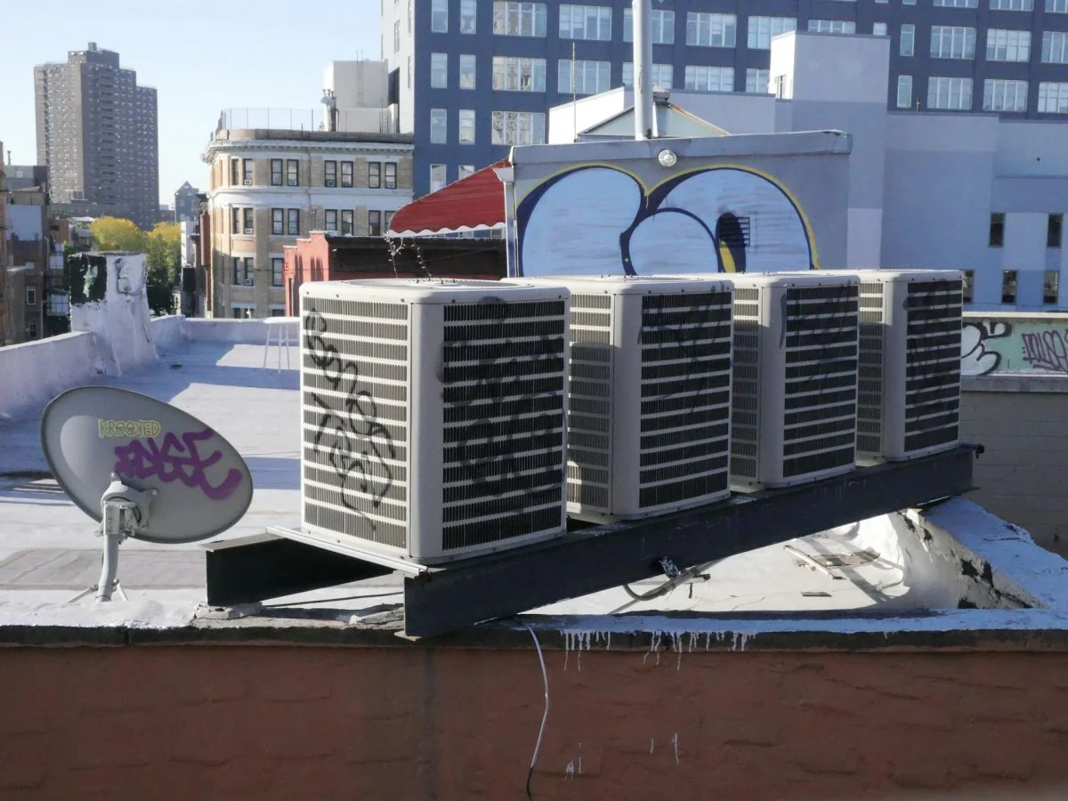 Multiple air conditioning units installed on a rooftop in Tucson, Arizona