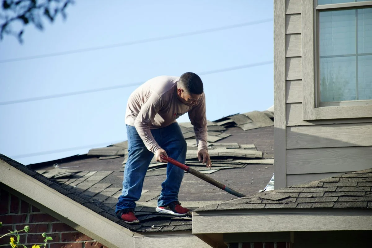 Roofing contractor repairing a roof leak on a residential home in Tucson, Arizona
