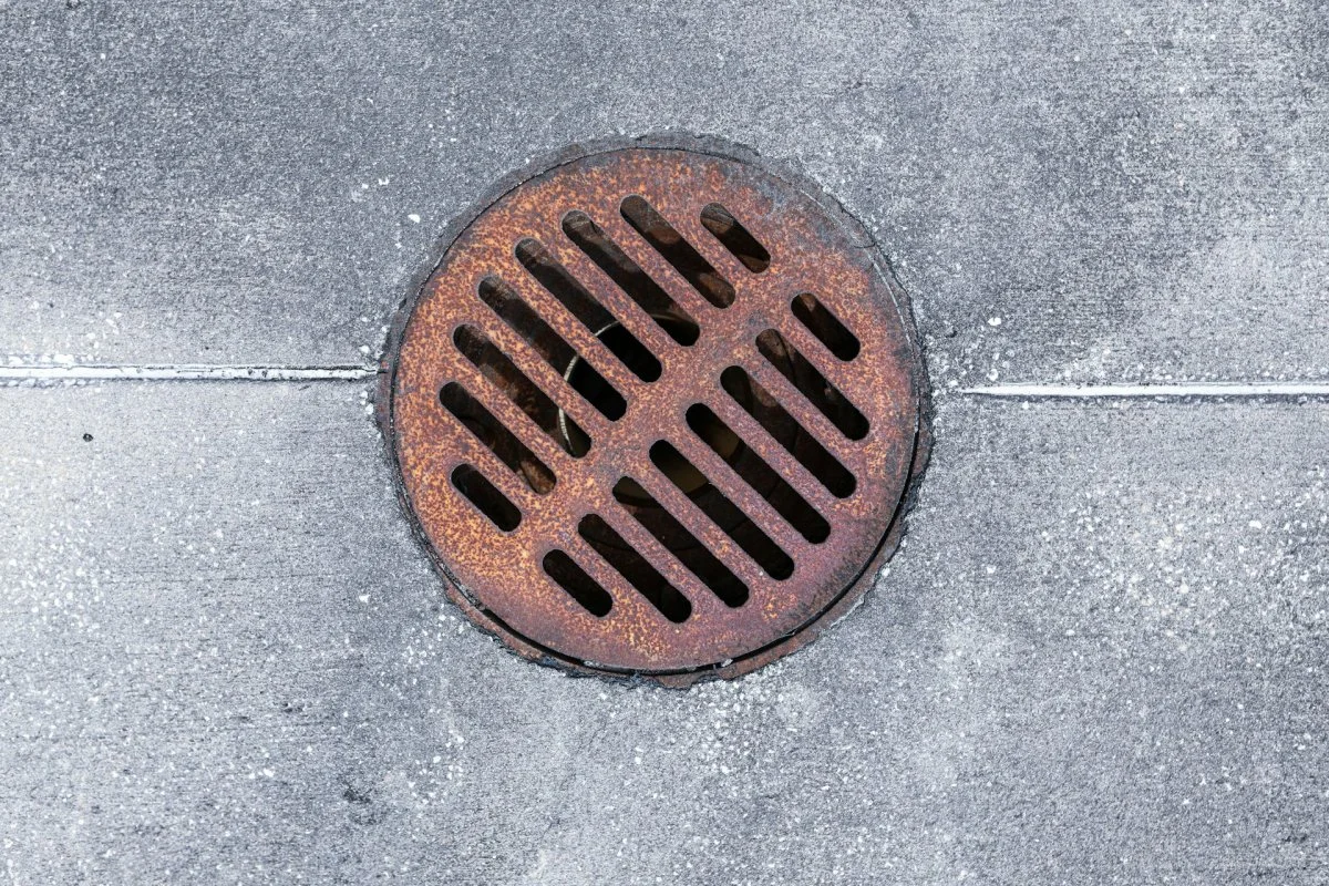 Floor drain with metal grate in a tiled surface in Tucson, Arizona