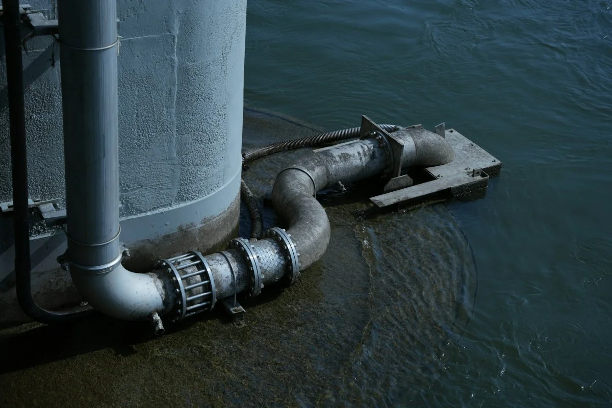 Water flowing through exposed pipes during extraction process in Tucson, Arizona